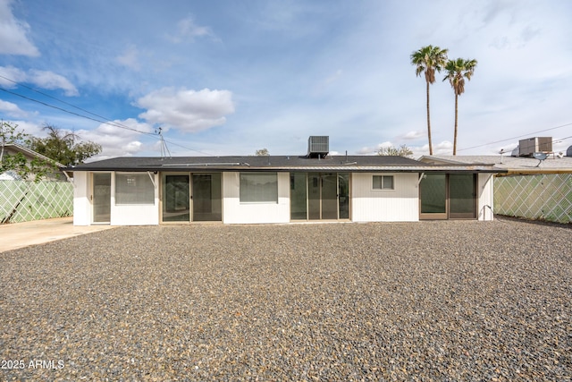 exterior space featuring central AC unit and fence