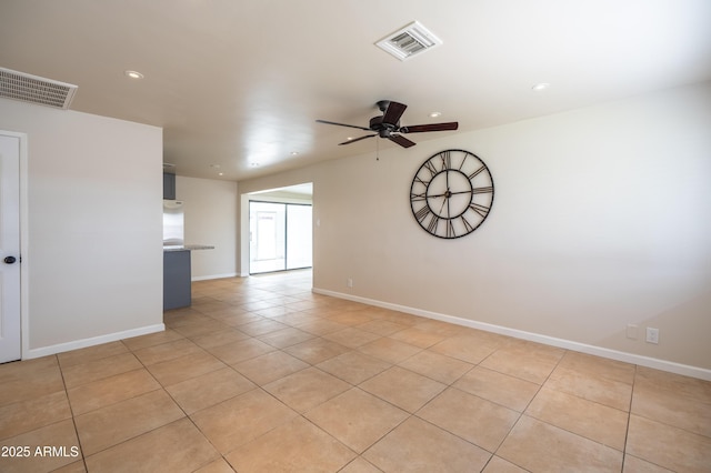 unfurnished room featuring a ceiling fan, visible vents, and baseboards