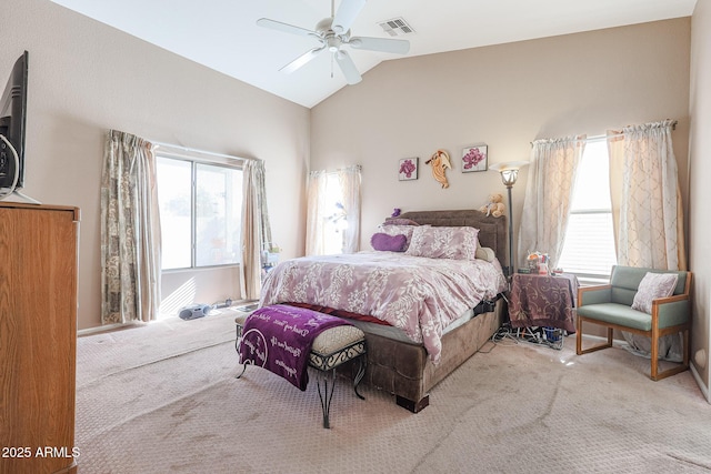 bedroom with ceiling fan, light colored carpet, lofted ceiling, and multiple windows