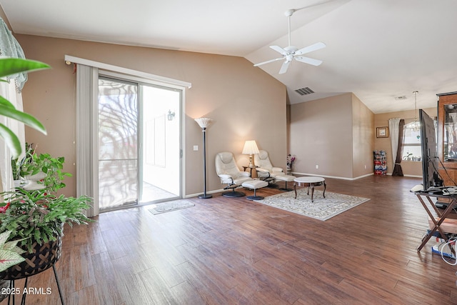 interior space with ceiling fan, dark hardwood / wood-style flooring, and vaulted ceiling