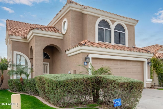 mediterranean / spanish-style home featuring a garage