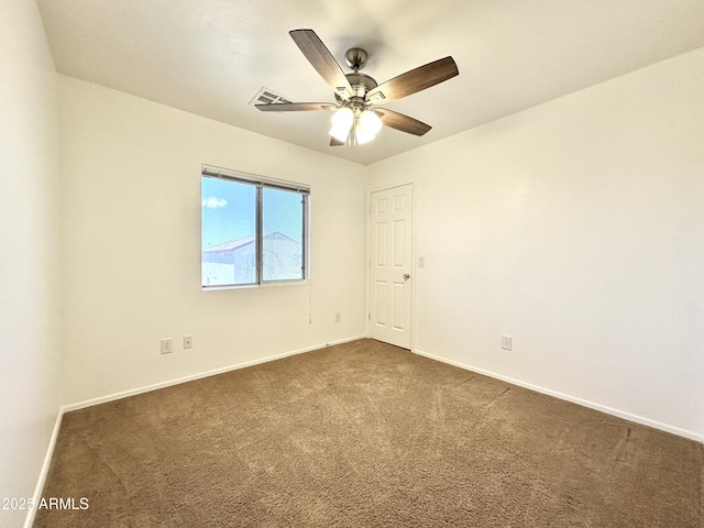 1649 W Wilson Ave, Coolidge, AZ 85128 - empty room with dark colored carpet and a ceiling fan