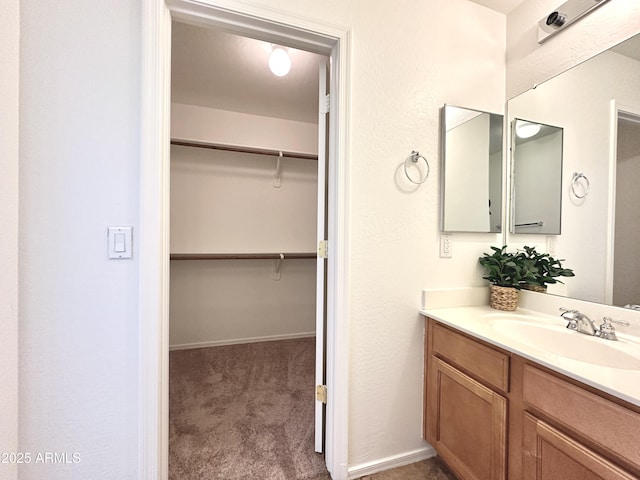 1649 W Wilson Ave, Coolidge, AZ 85128 - bathroom with vanity and a walk in closet