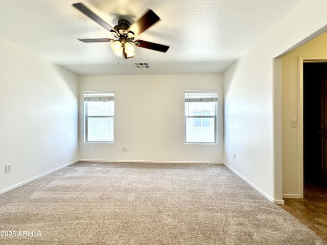 1649 W Wilson Ave, Coolidge, AZ 85128 - spare room featuring plenty of natural light, ceiling fan, carpet flooring, and a textured ceiling