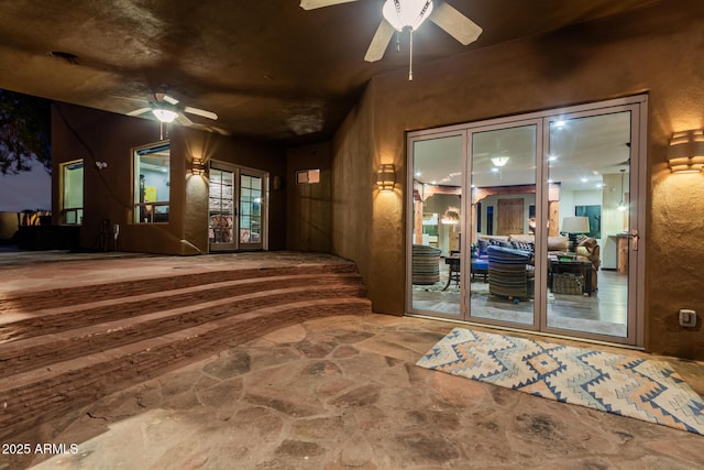 doorway to property featuring ceiling fan, a patio, and french doors
