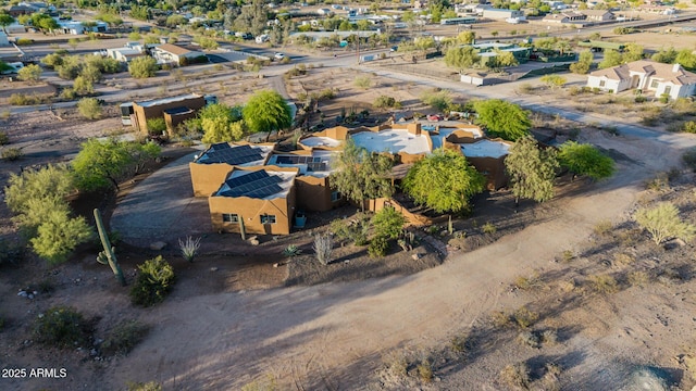 aerial view of property and surrounding area featuring nearby suburban area