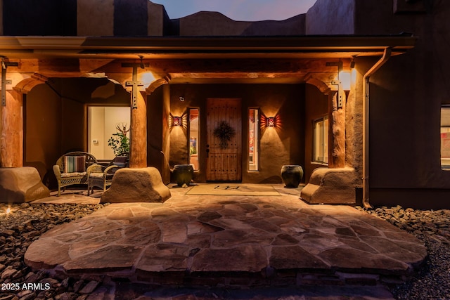 entrance to property featuring a patio