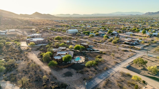 aerial overview of property's location featuring a mountainous background and nearby suburban area