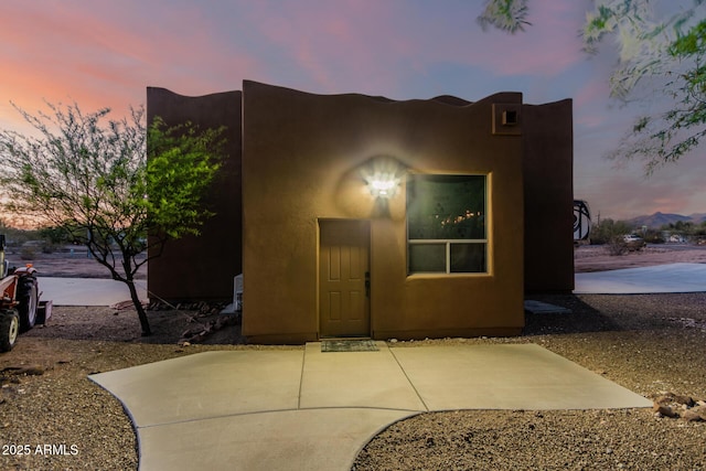 view of front of property featuring a patio area and stucco siding