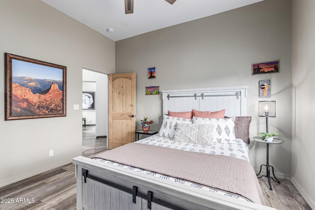 bedroom with wood finished floors, baseboards, and ceiling fan