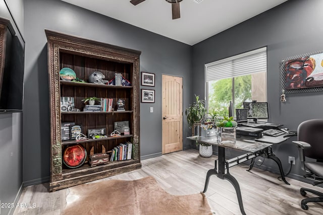 office area featuring ceiling fan, wood finished floors, and baseboards