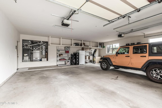 garage with a garage door opener and heating unit