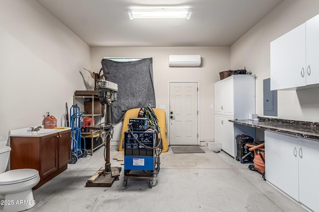 garage featuring a wall mounted air conditioner and electric panel