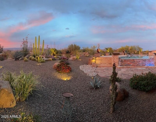 view of yard at dusk