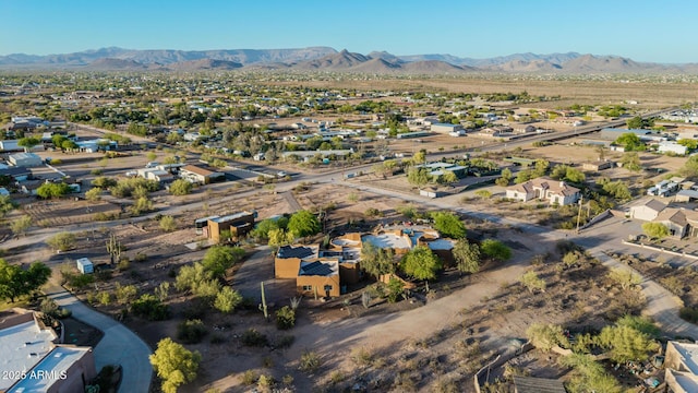 aerial overview of property's location with a mountainous background and nearby suburban area