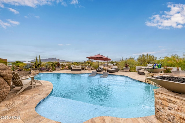 swimming pool featuring an outdoor hangout area, a patio, and a mountain view