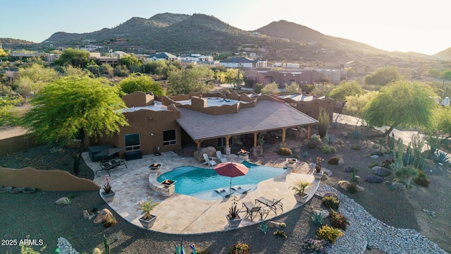 view of subject property featuring mountains and a pool