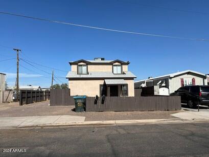 view of front of house with a fenced front yard and stucco siding