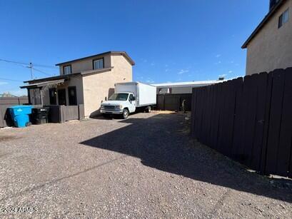 exterior space with stucco siding and fence