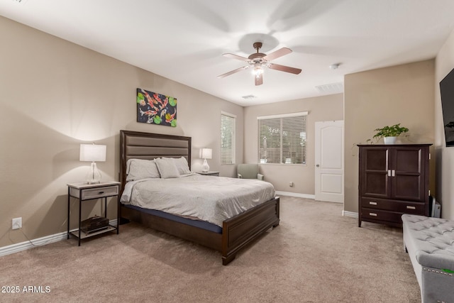 bedroom featuring baseboards, visible vents, a ceiling fan, and light carpet