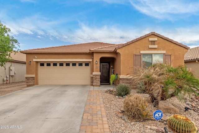 view of front of home with driveway, stucco siding, a garage, and stone siding
