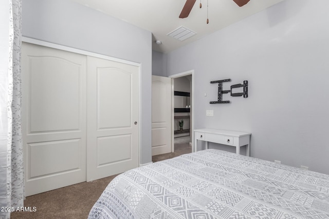 carpeted bedroom featuring a closet, ceiling fan, and visible vents