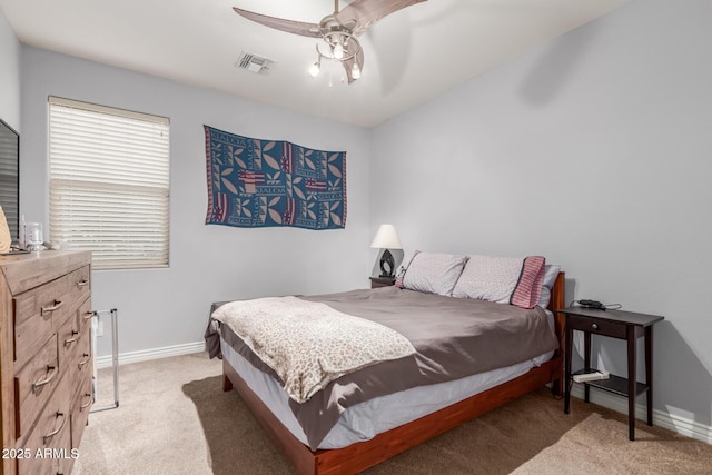 bedroom with light colored carpet, visible vents, ceiling fan, and baseboards