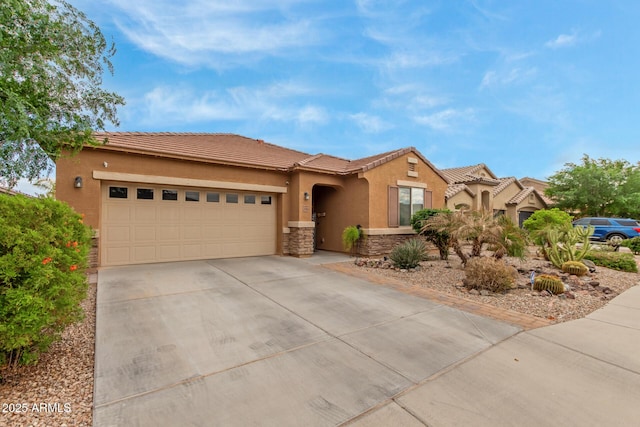 view of front facade featuring stucco siding, an attached garage, stone siding, a tiled roof, and driveway