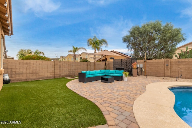 view of pool featuring outdoor lounge area, a fenced backyard, a patio, and a yard