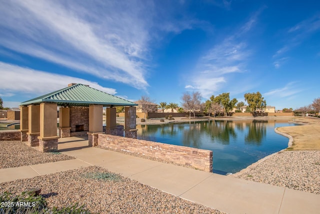 exterior space featuring a gazebo and a water view