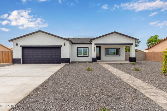 ranch-style home featuring a garage