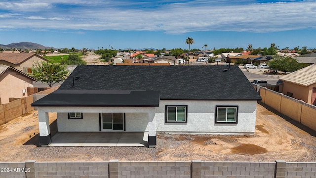 back of property featuring a patio and a mountain view