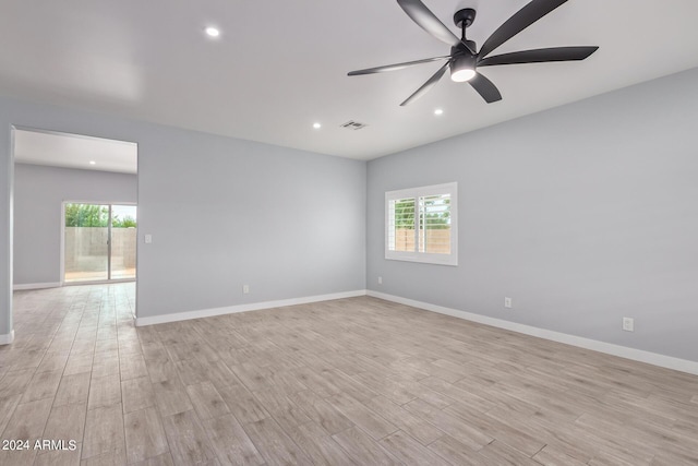 empty room with ceiling fan and light wood-type flooring