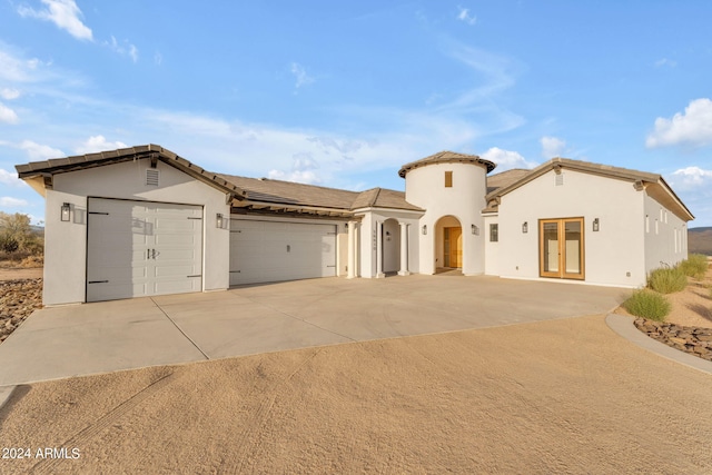 mediterranean / spanish house with a garage