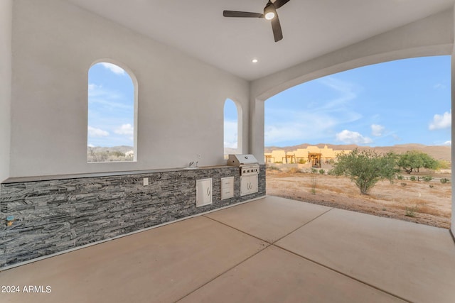 view of patio featuring area for grilling, an outdoor kitchen, and ceiling fan