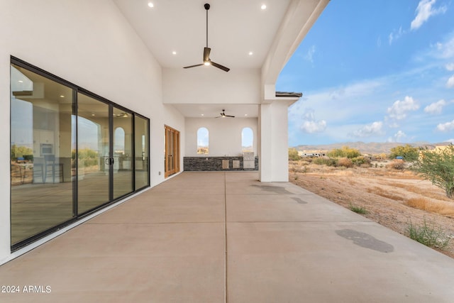 view of patio / terrace featuring a mountain view and ceiling fan