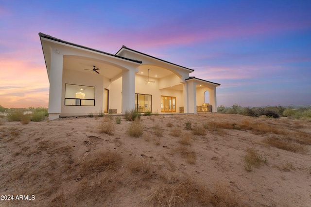 back house at dusk with ceiling fan