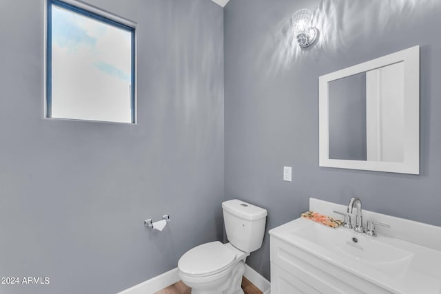 bathroom with vanity, toilet, and plenty of natural light