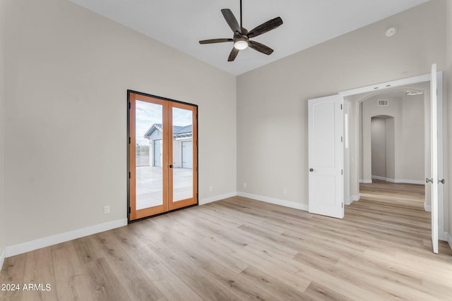 spare room featuring french doors, ceiling fan, and light hardwood / wood-style flooring