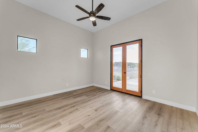 unfurnished room featuring french doors, light wood-type flooring, and ceiling fan