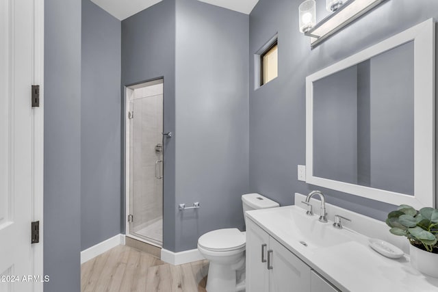 bathroom with vanity, a shower with shower door, wood-type flooring, and toilet