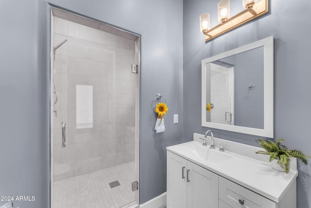 bathroom with vanity and a shower with shower door