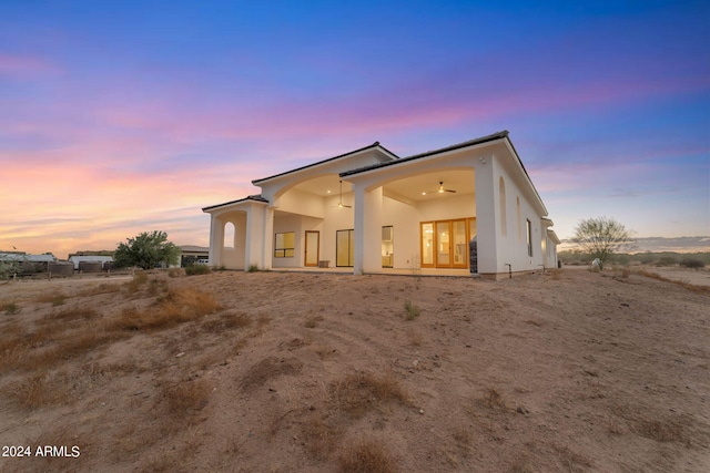 view of back house at dusk