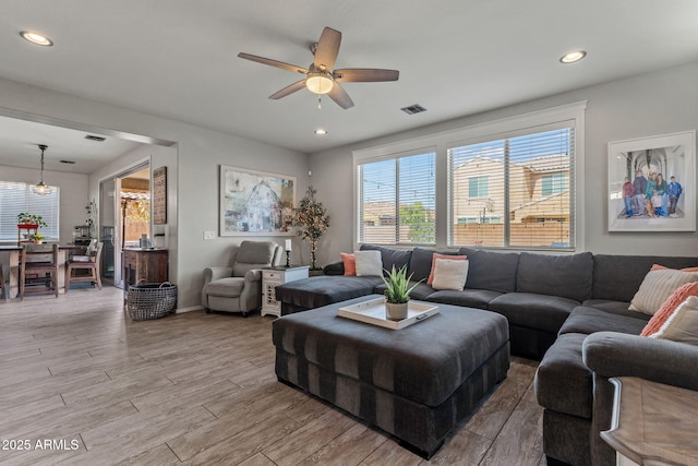 living room with ceiling fan and light hardwood / wood-style floors