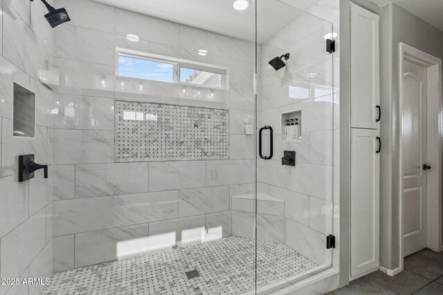 bathroom featuring a shower with door