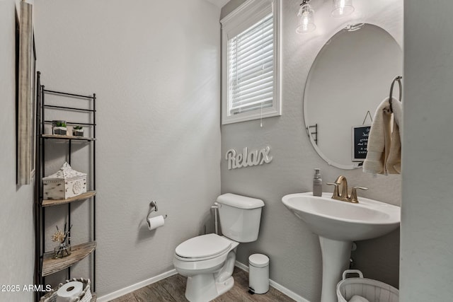 bathroom featuring hardwood / wood-style floors and toilet