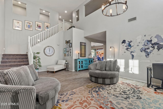 living room with an inviting chandelier, wood-type flooring, and a high ceiling