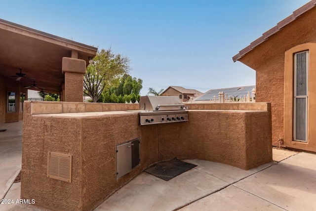 view of patio with ceiling fan and area for grilling