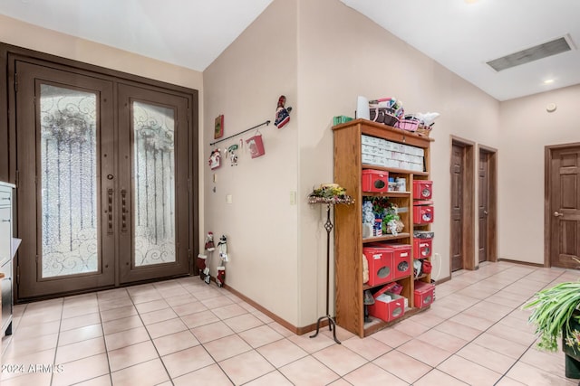 foyer entrance featuring french doors and light tile patterned flooring