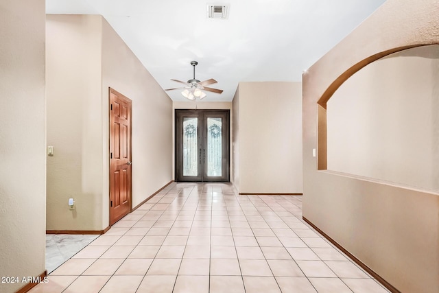 foyer entrance featuring ceiling fan, light tile patterned floors, and french doors